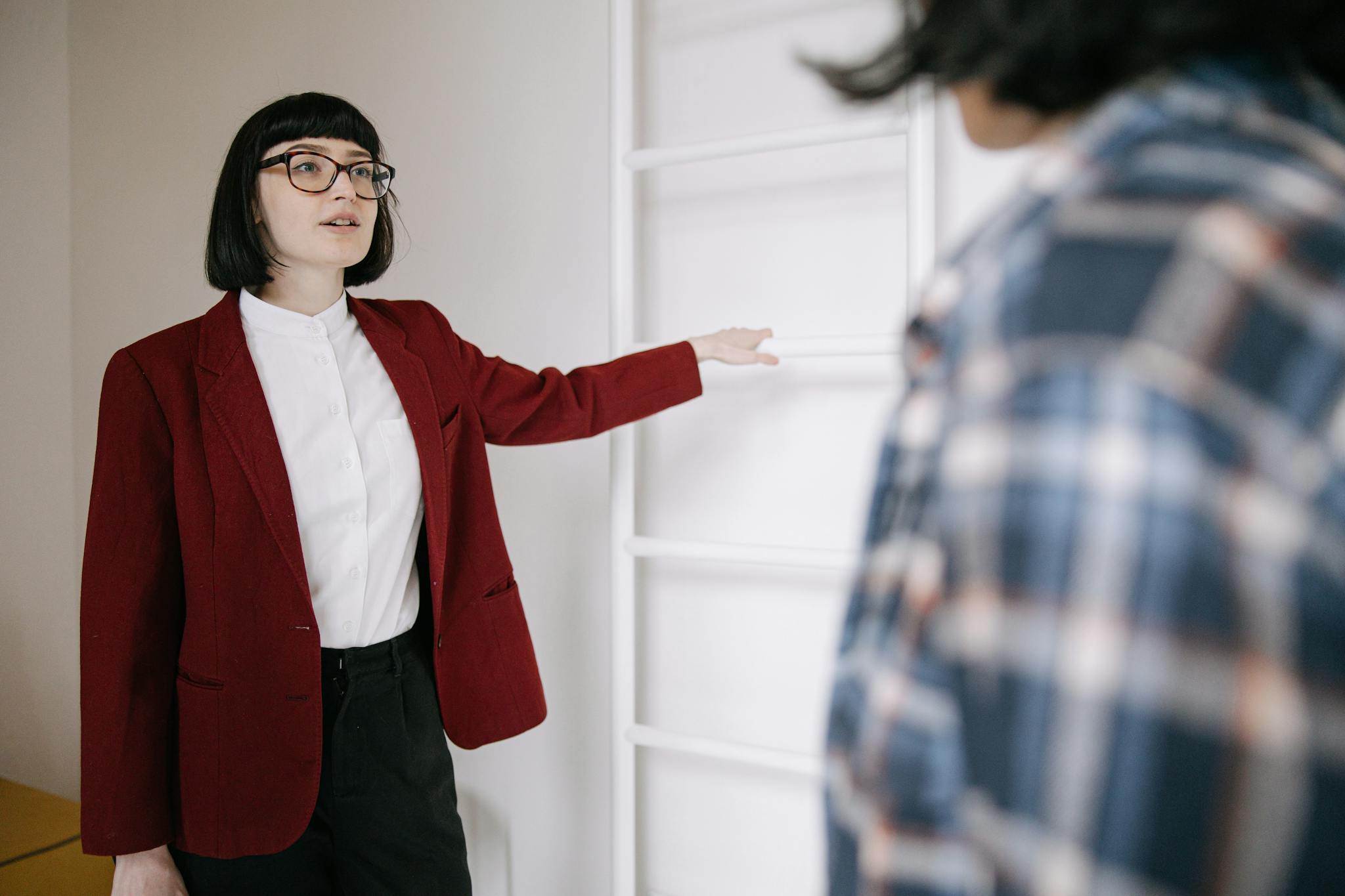 Professional woman showcasing property space to potential buyer
